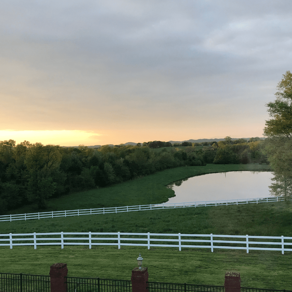 Pond and white fence at sunset at Grahams Estate Gallatin TN