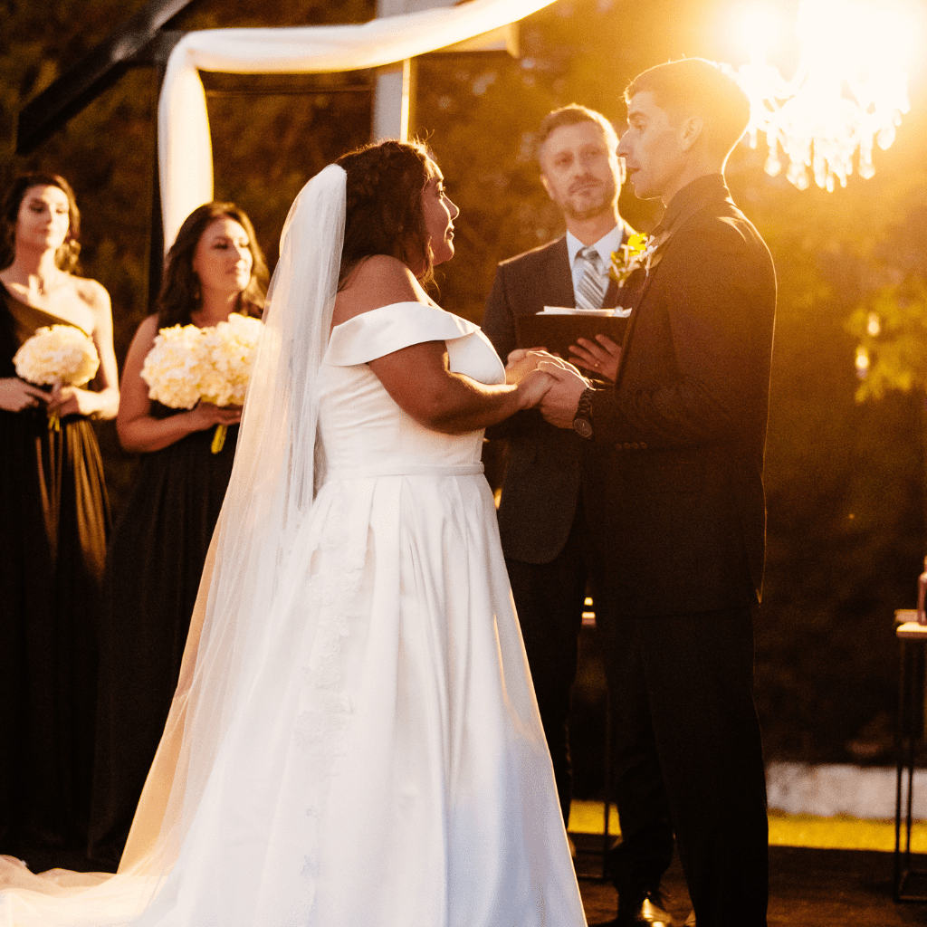 Bride and groom exchanging vows during sunset at Grahams Estate