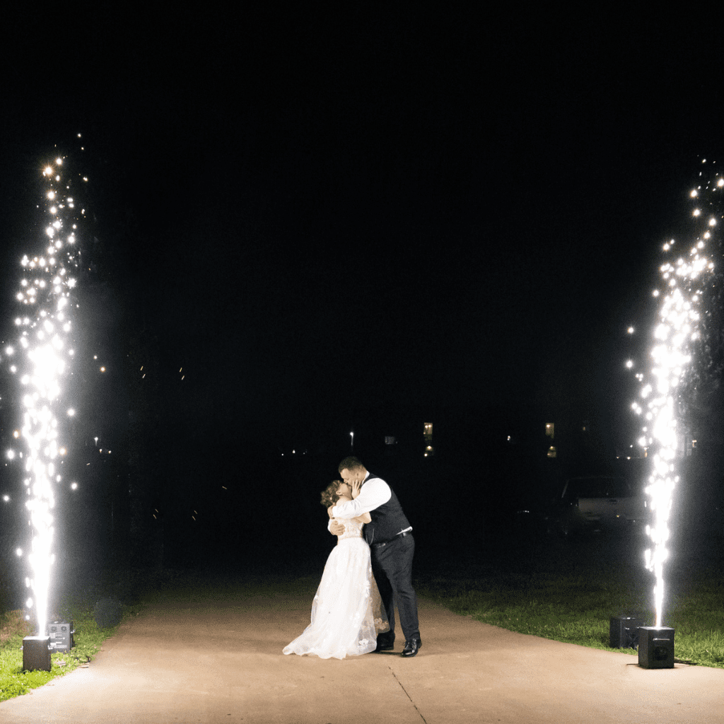 Bride and groom kissing in front of fireworks at Grahams Estate