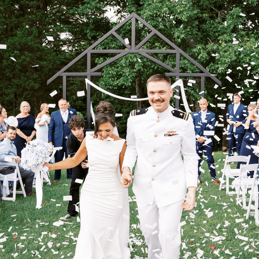 Bride and groom walking through confetti after wedding ceremony at Grahams Estate Gallatin TN