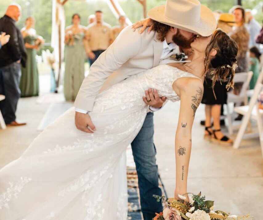 Groom dips bride for romantic kiss at Gallatin wedding venue