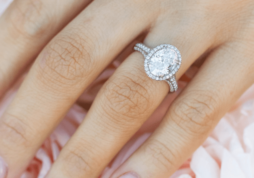 Oval diamond engagement ring on hand