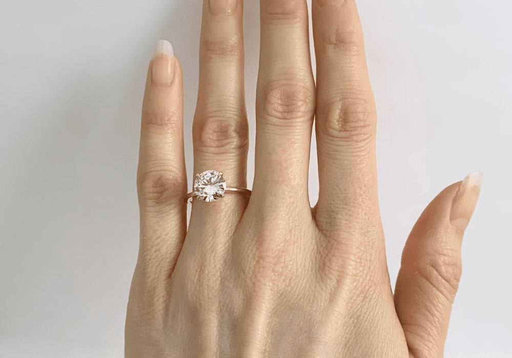 Solitaire engagement ring setting on slim band