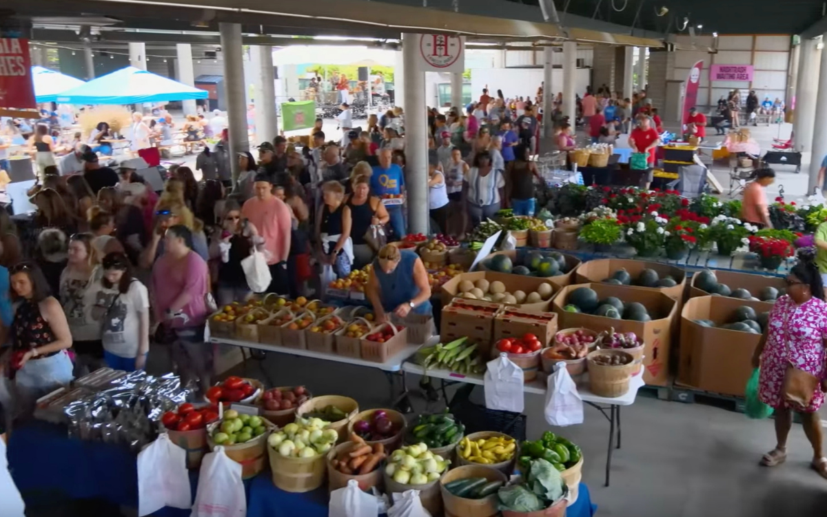 People enjoying brunch and shopping at Nashville Farmers Market in summer