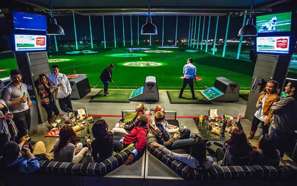 Friends playing at Topgolf Nashville during a bachelor party