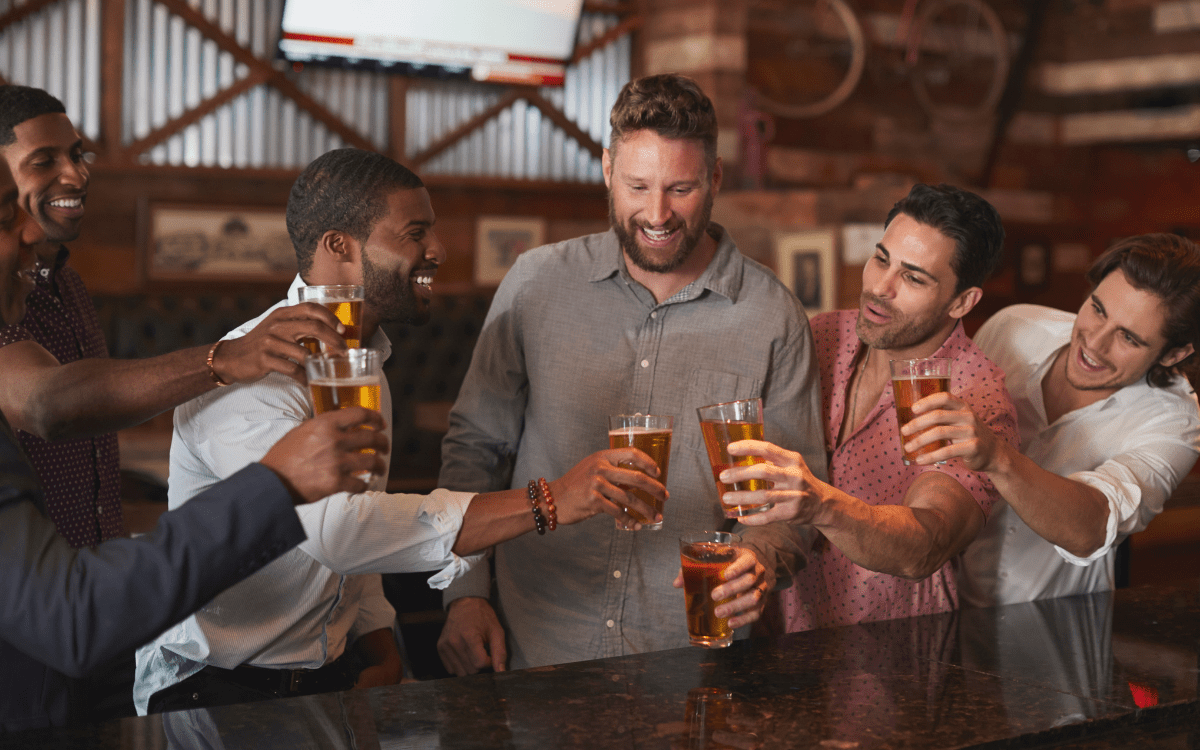 Friends planning a Nashville bachelor weekend over drinks