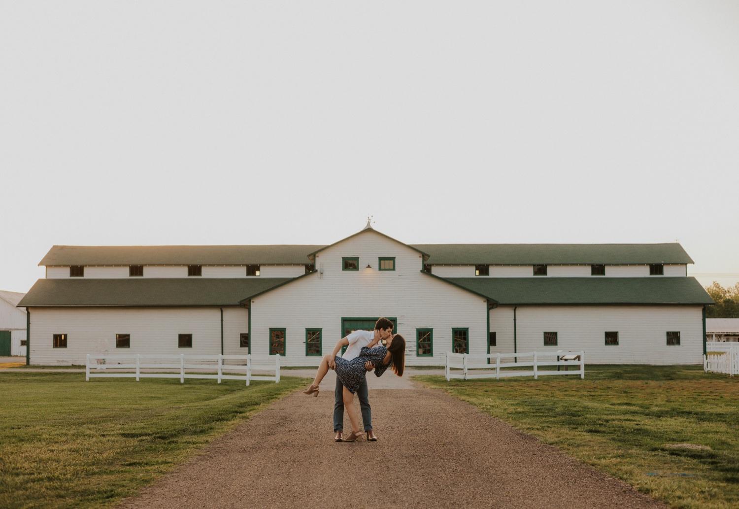 Couple walking through an open field at Harlinsdale Farm in Franklin, Tennessee