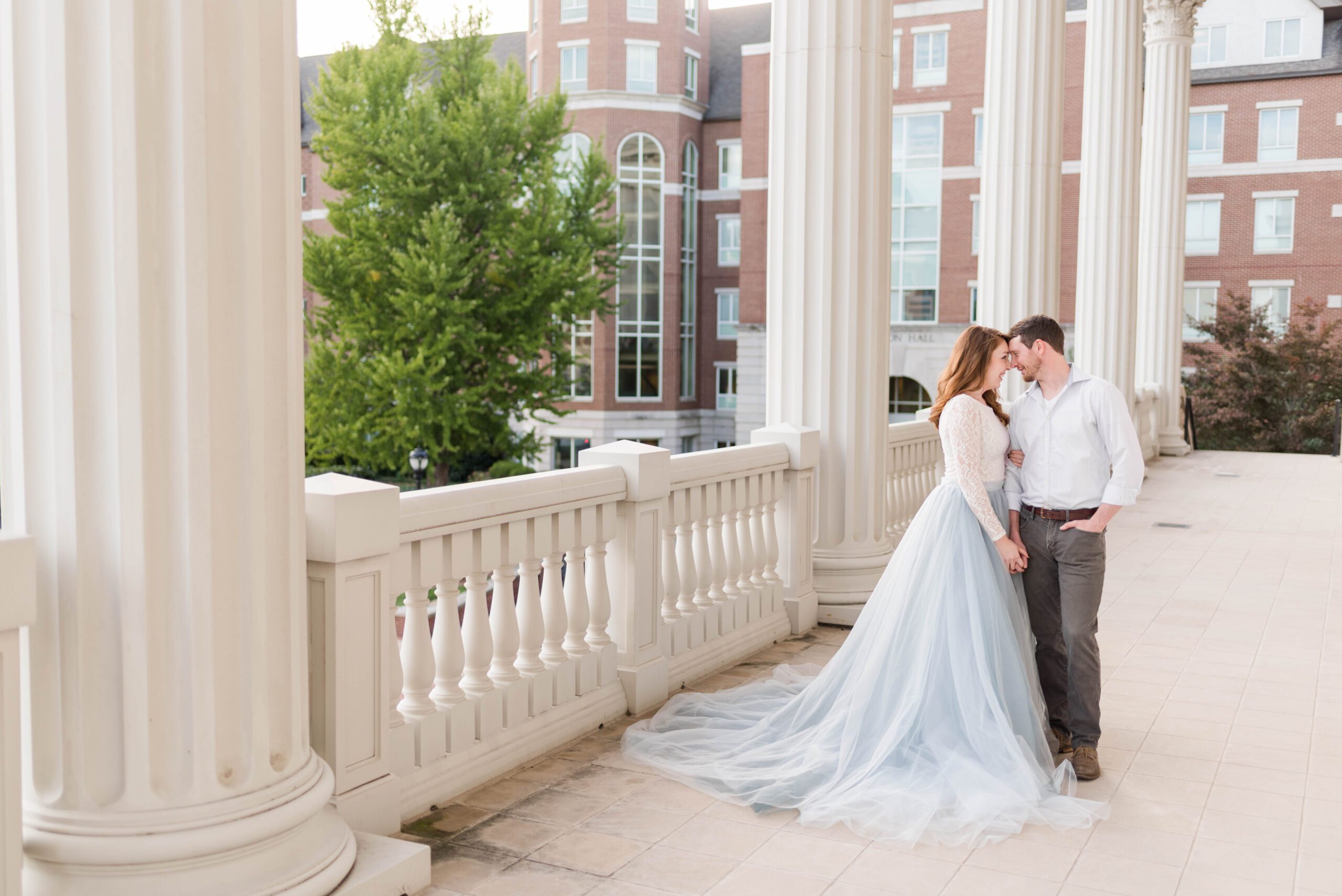 Couple walking past historic buildings on Belmont University campus in Nashville