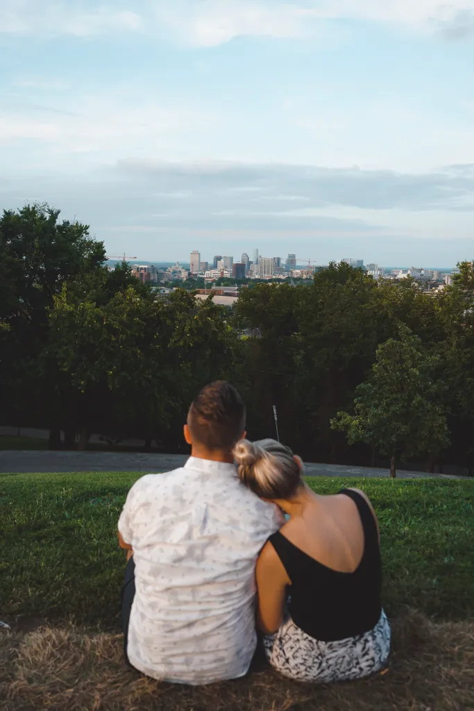Couple sitting on a blanket overlooking the Nashville skyline from Love Circle