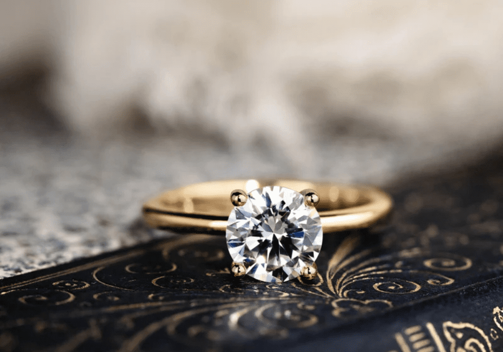 Classic round solitaire diamond engagement ring on slim band