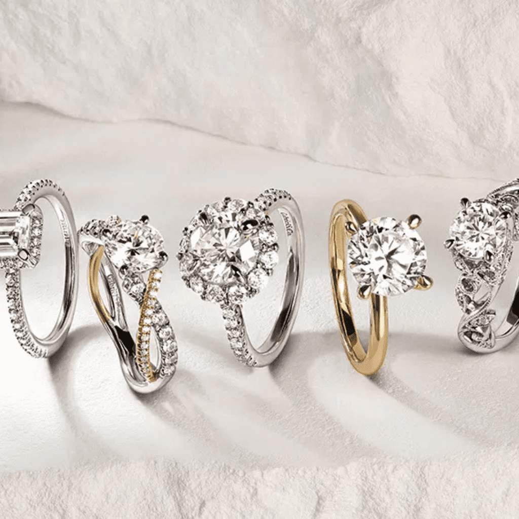 Multiple engagement ring settings displayed together on a tray