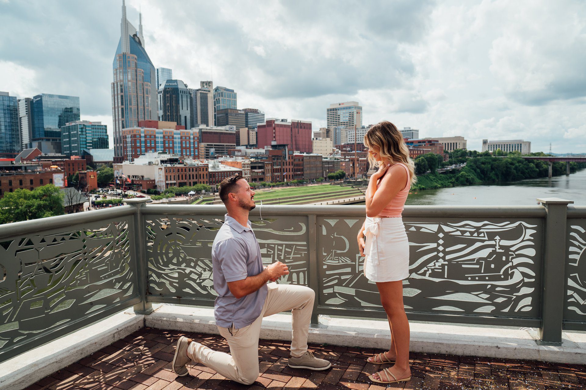 Couple on the John Seigenthaler Pedestrian Bridge with the Nashville skyline behind them