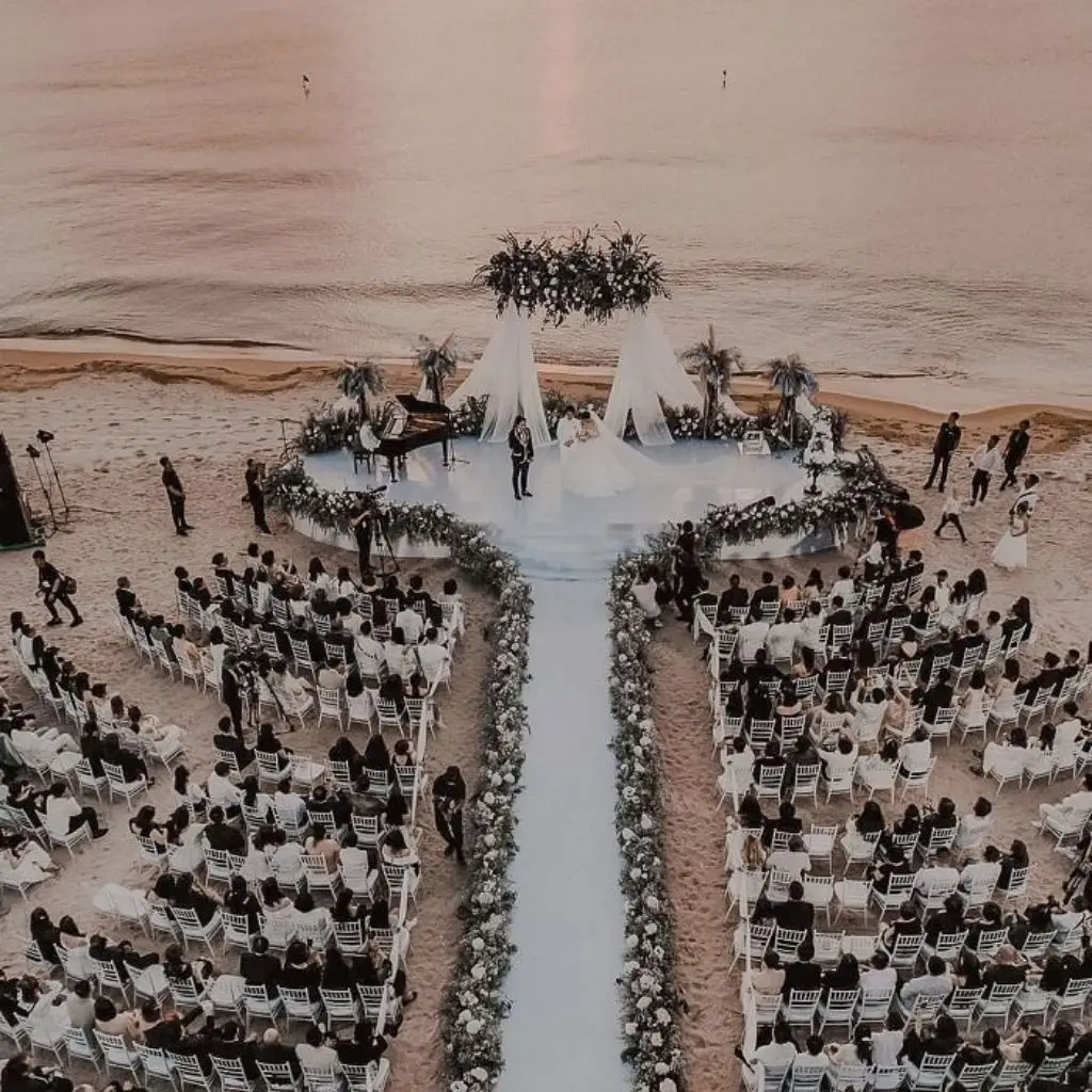 Beach wedding ceremony with ocean backdrop and soft coastal florals