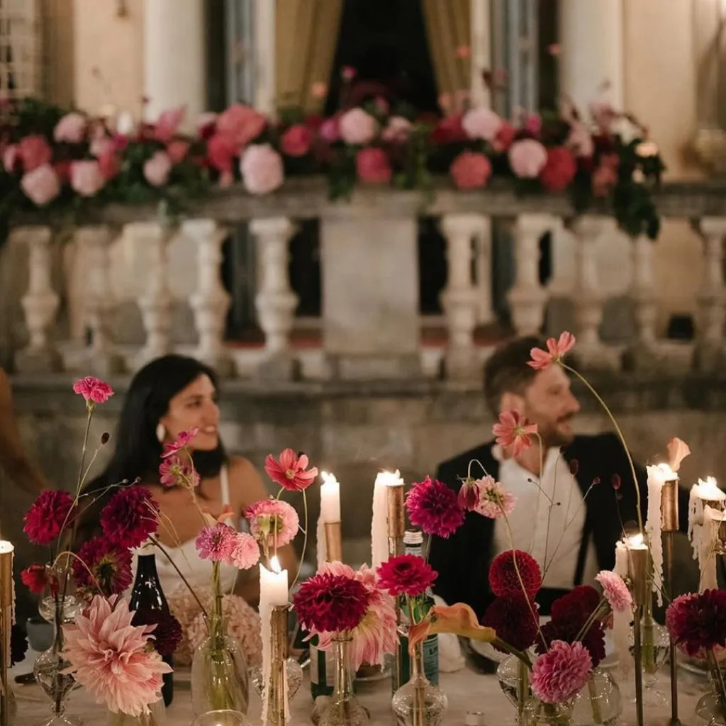 Wedding reception styled with rich colors, warm lighting, and expressive décor