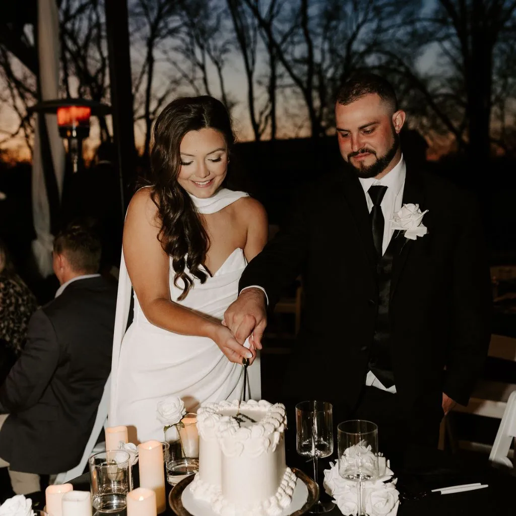 Bride and groom cutting their wedding cake together during a reception at Grahams Estate in Gallatin, Tennessee.