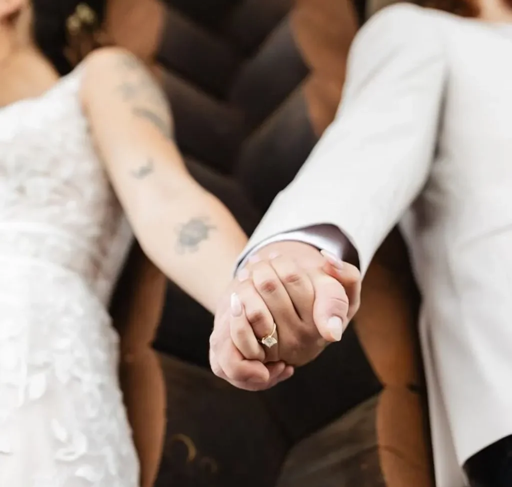 Bride and groom holding hands during their wedding at Grahams Estate in Gallatin TN