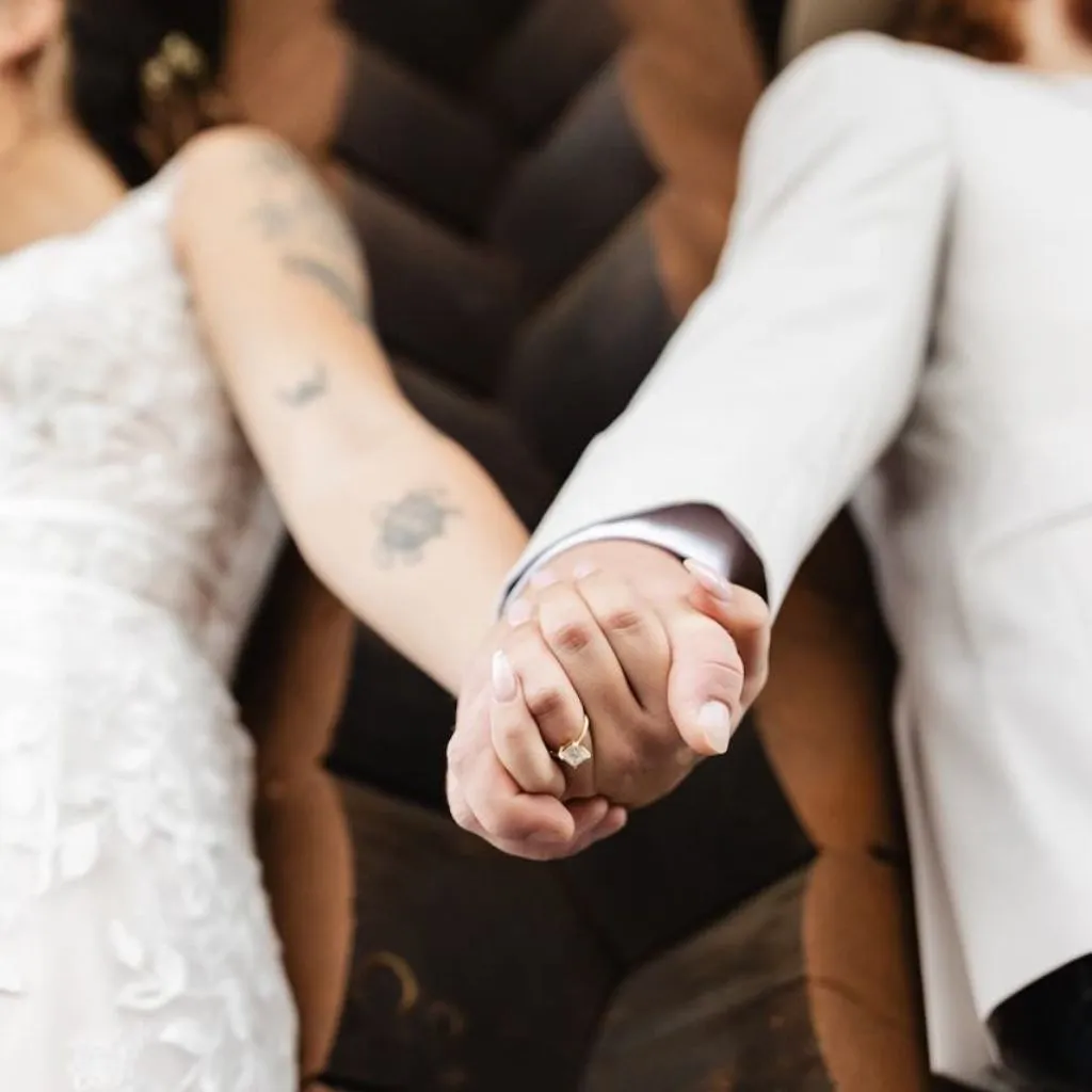 Bride and groom holding hands during their wedding at Grahams Estate in Gallatin TN