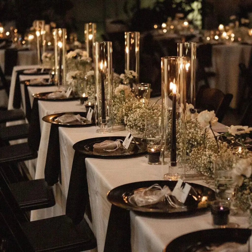 Black-tie wedding celebration with candlelight and refined estate architecture