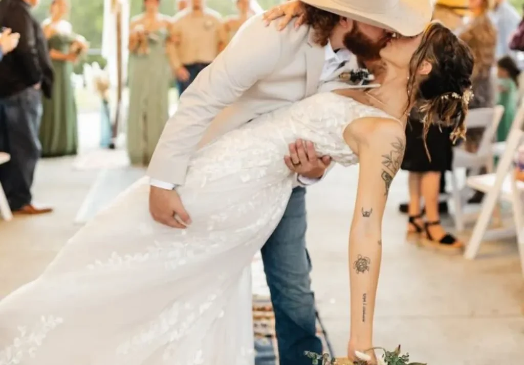 Groom in cowboy hat dipping the bride for a kiss at Grahams Estate wedding venue in Gallatin TN.