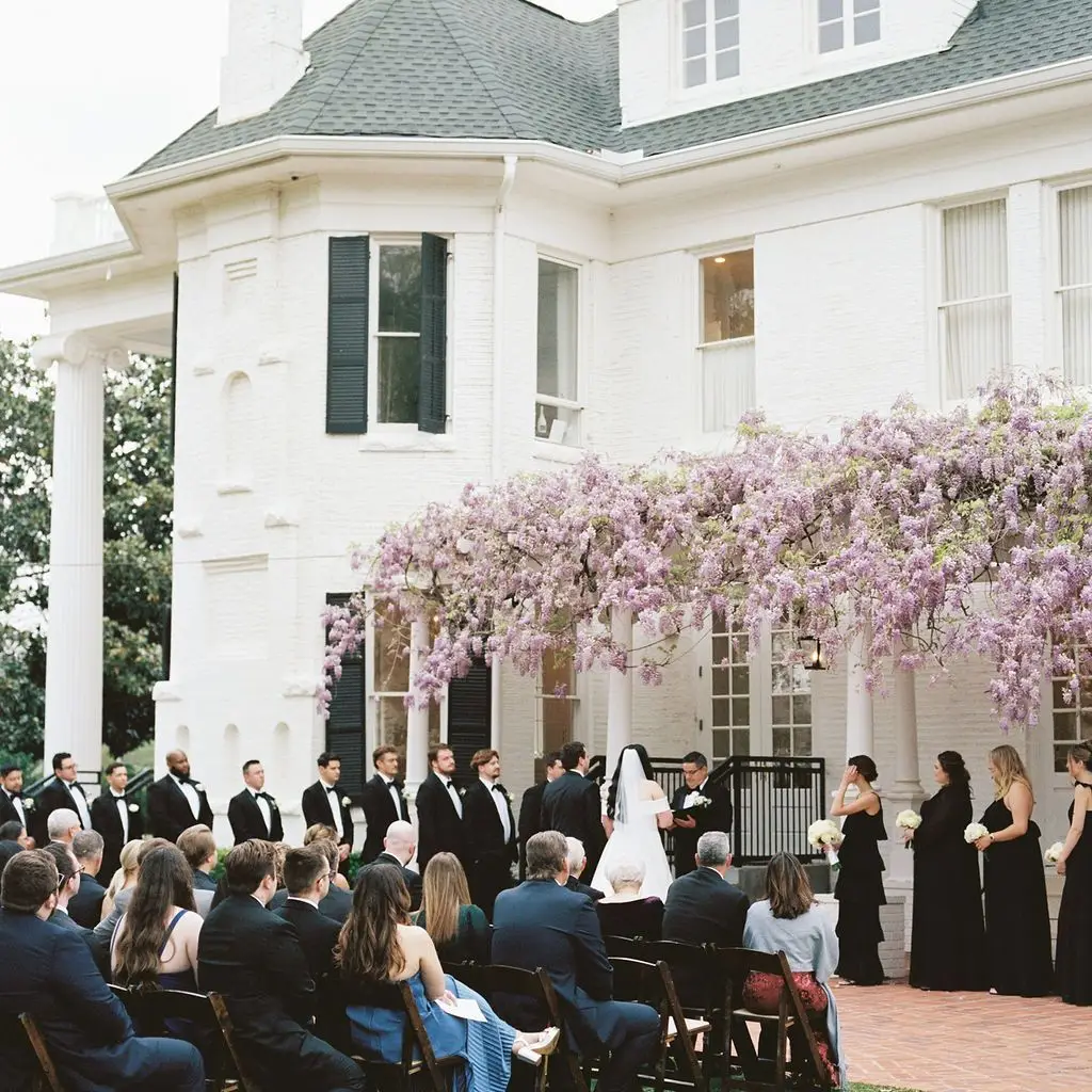Estate wedding ceremony with historic mansion backdrop