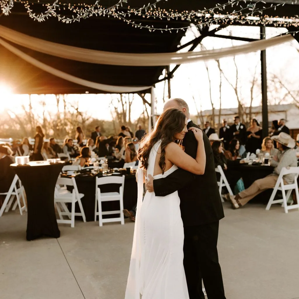 Bride sharing an emotional father–daughter dance at sunset during a wedding reception at Grahams Estate in Gallatin, TN.