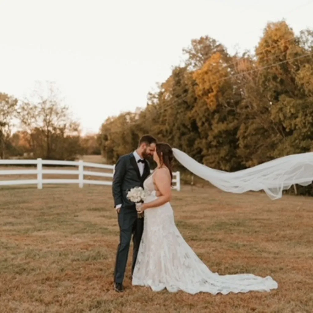 Bride and groom sharing a tender moment with flowing veil at a wedding venue in Gallatin TN.