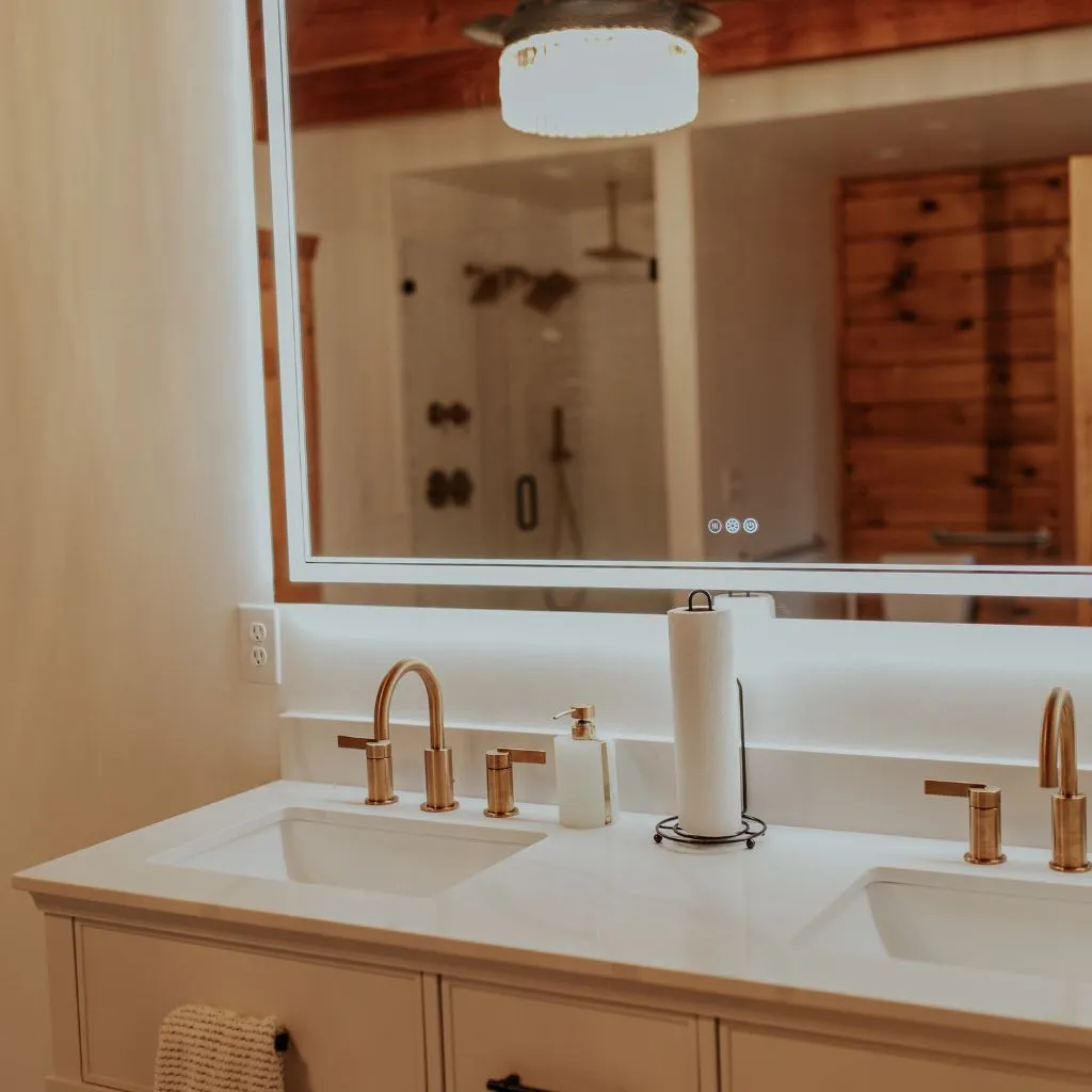 Bridal suite bathroom vanity with double sinks and backlit mirror at Grahams Estate in Gallatin TN