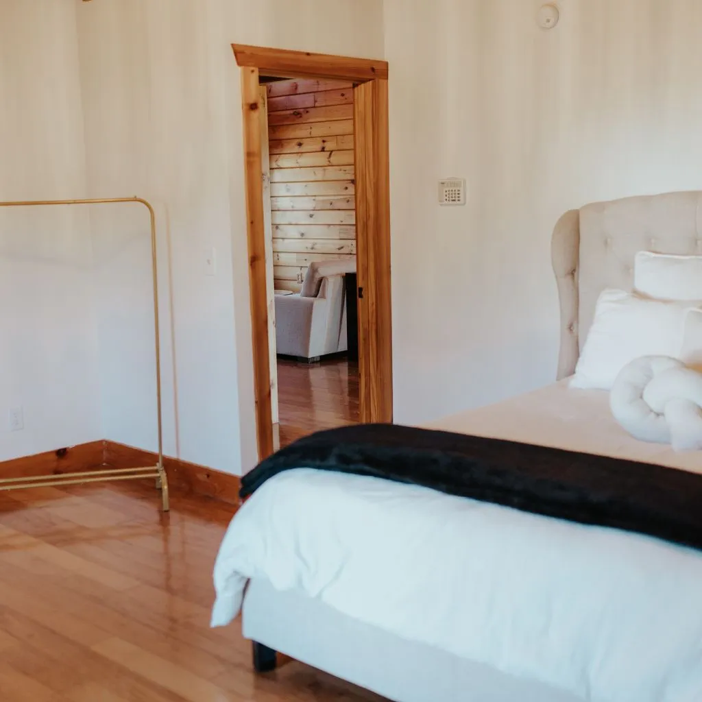 Bridal suite bedroom with natural light and cozy seating at Grahams Estate wedding venue