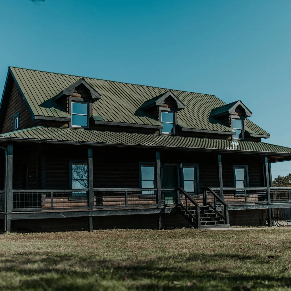 Exterior of the Grahams Estate bridal suite cabin with large porch and metal roof