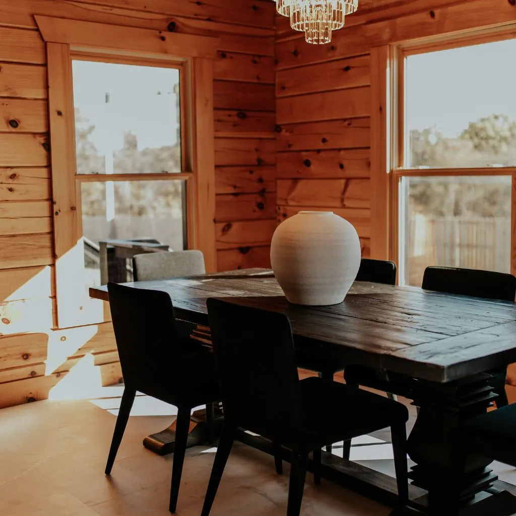 Dining area inside the Grahams Estate bridal suite with wooden table and modern chairs
