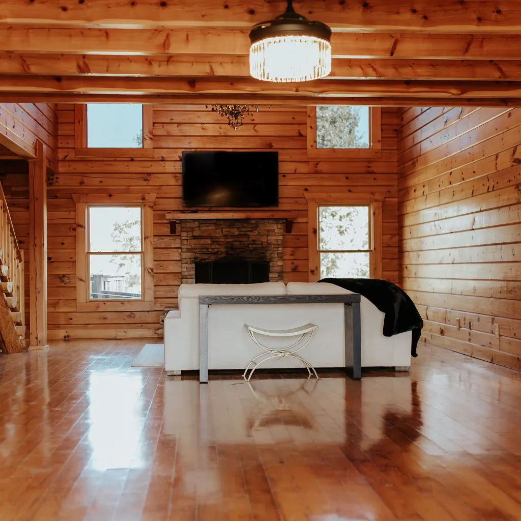 Bridal suite living room with fireplace and natural wood walls at Grahams Estate