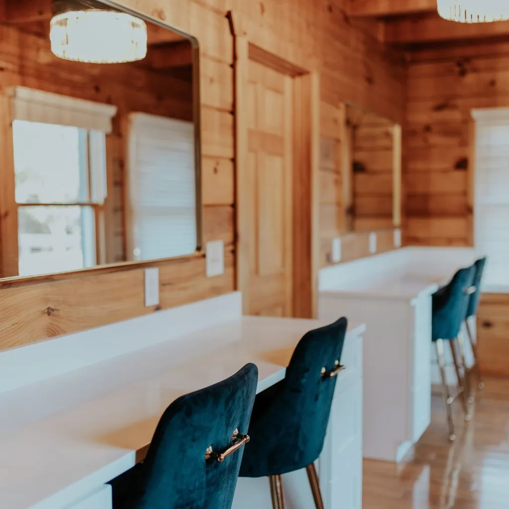 Bridal suite vanity stations with mirrors and navy chairs at Grahams Estate in Gallatin TN