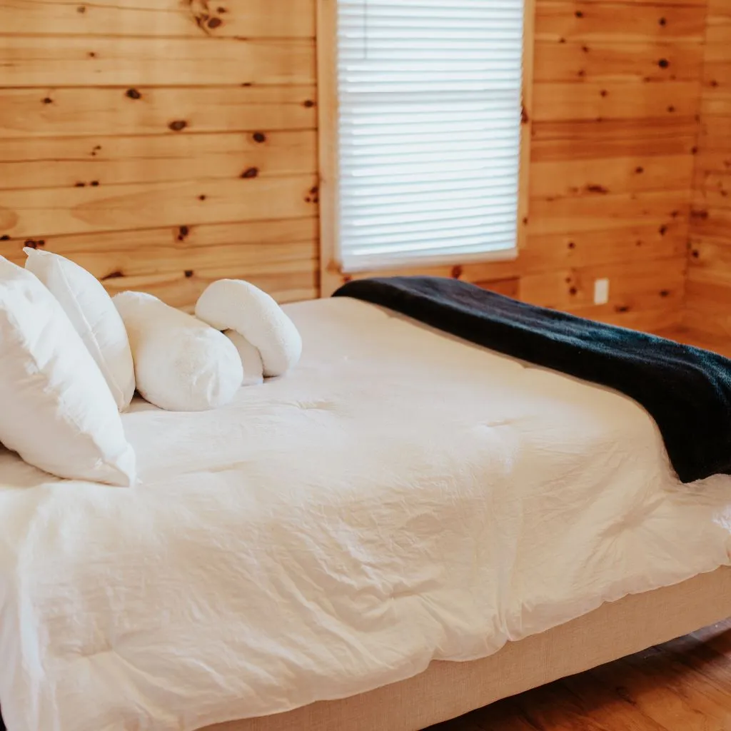 Groom’s suite bedroom with white linens at Grahams Estate Gallatin TN