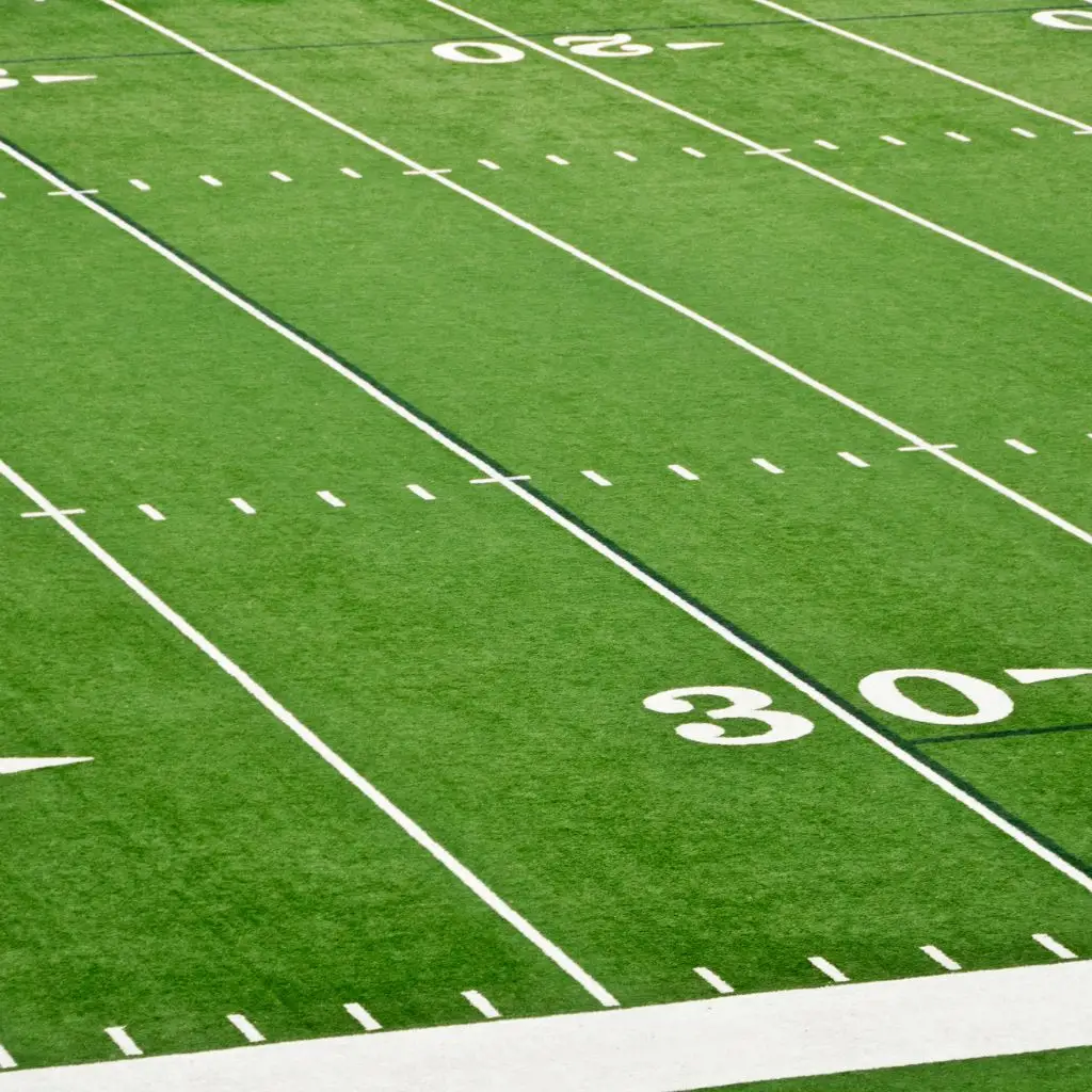 Close-up of the 30-yard line on a green football field in Tennessee