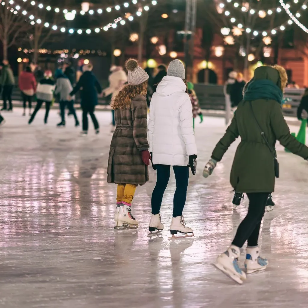 People ice skating at an outdoor holiday rink in Nashville