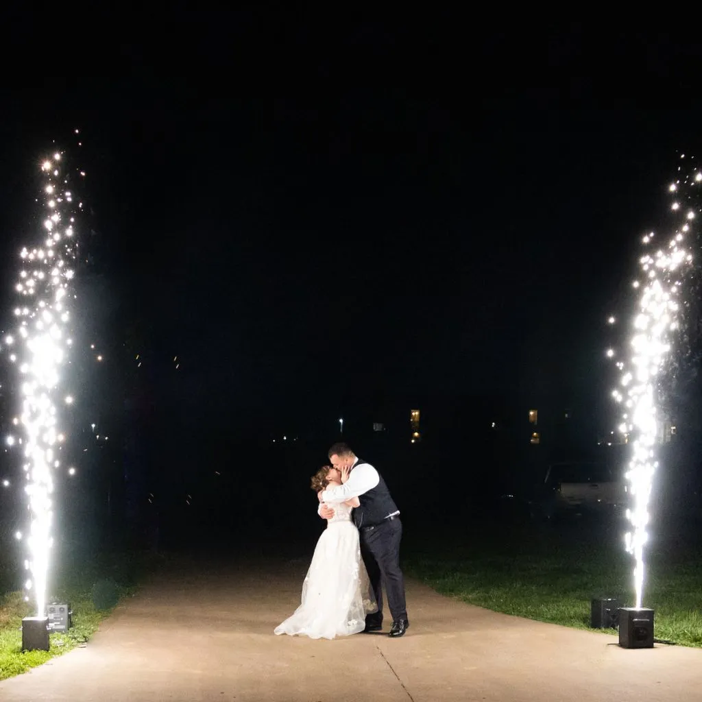 Bride and groom sharing a kiss during a nighttime sparkler exit at Grahams Estate in Gallatin TN.