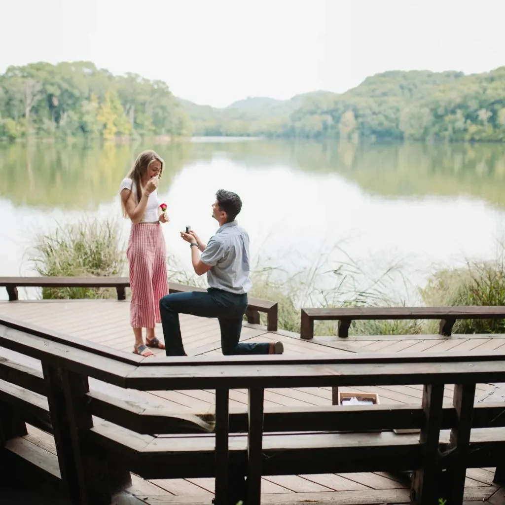 Couple standing on a dock during a foggy Radnor Lake engagement session in Nashville.