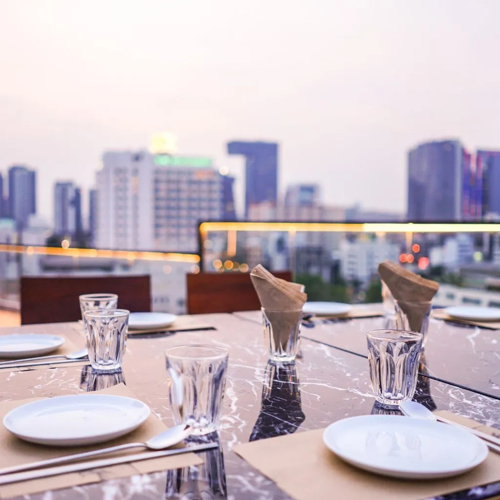 Rooftop rehearsal dinner table overlooking the Nashville skyline