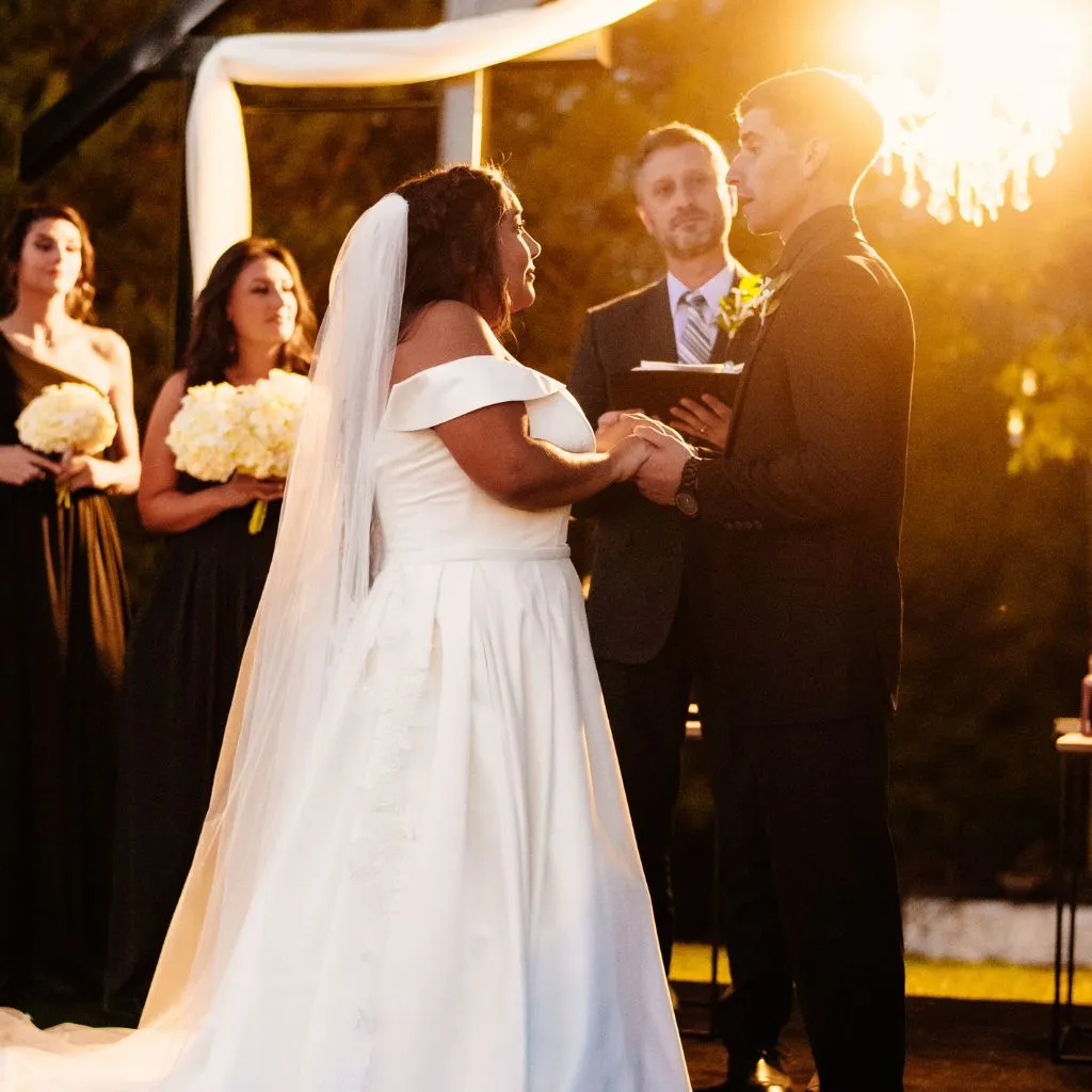 Bride and groom exchanging vows at sunset at Grahams Estate wedding venue in Gallatin TN.