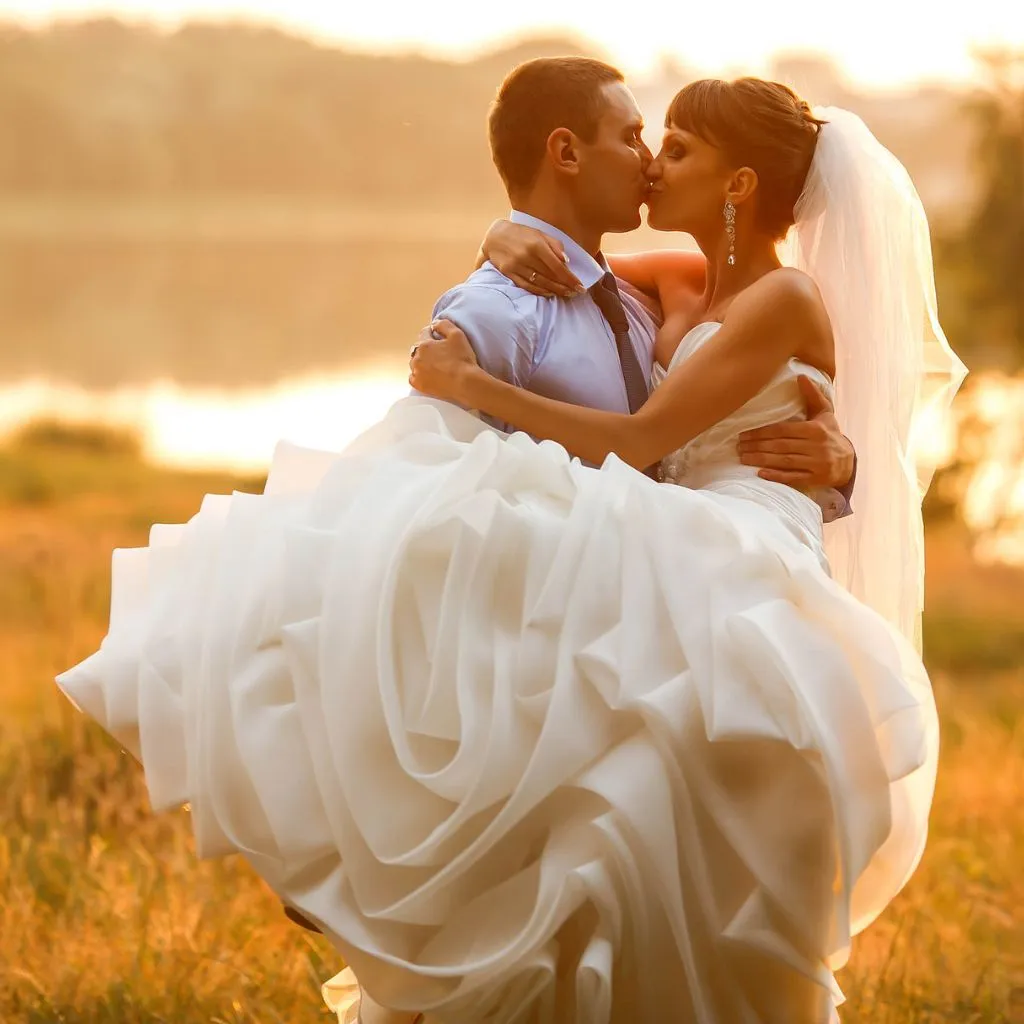 Groom carrying the bride during a sunset wedding portrait at Grahams Estate in Gallatin TN