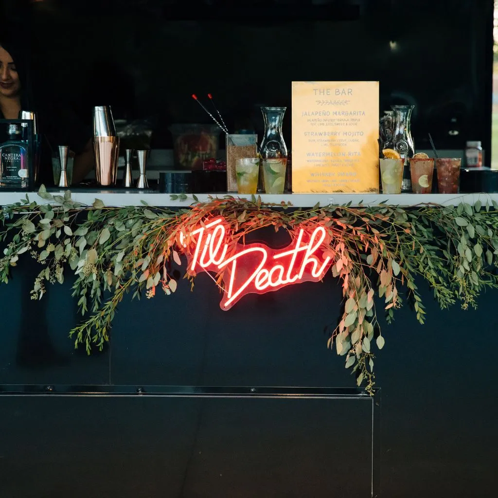 Custom wedding bar setup with a neon ’Til Death sign and signature cocktails at Grahams Estate in Gallatin, Tennessee.