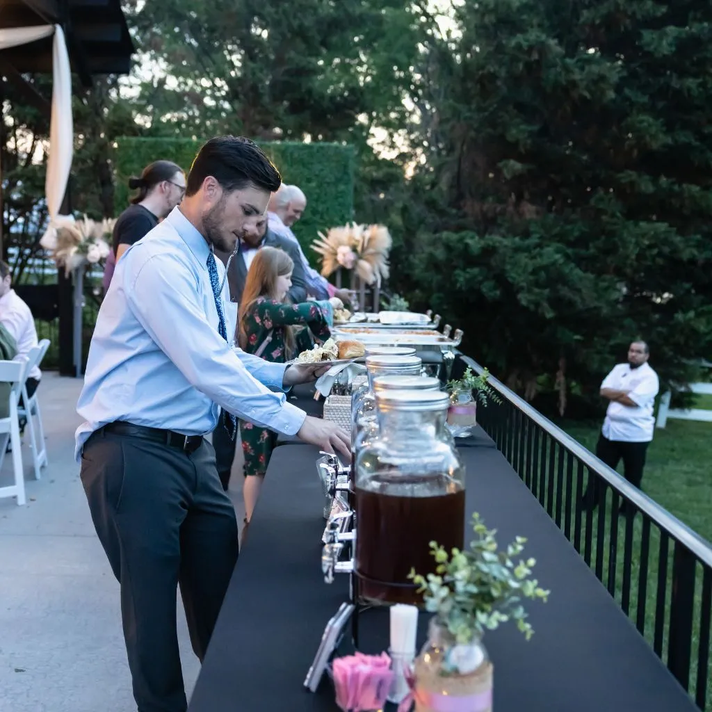 Guests serving themselves at the outdoor wedding reception buffet at Grahams Estate in Gallatin, Tennessee.
