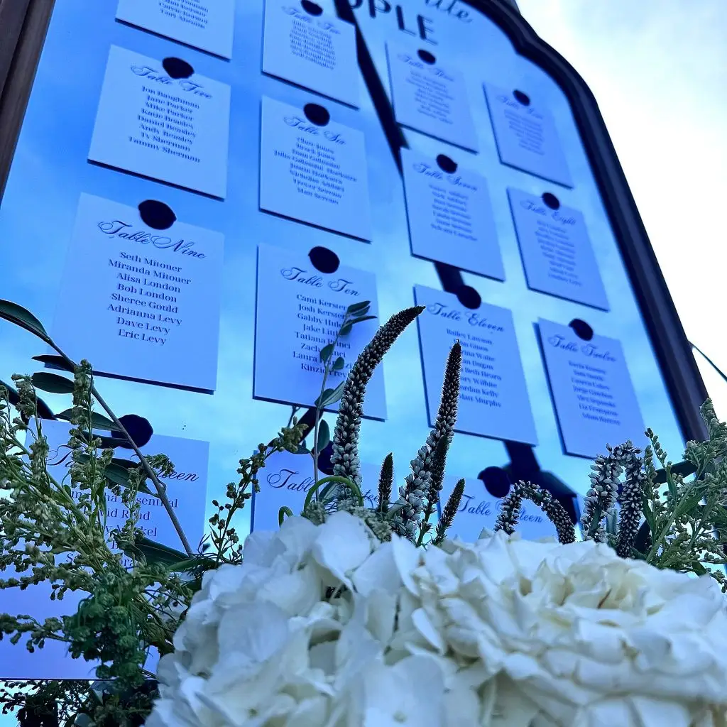 Elegant floral-accented wedding seating chart displayed outdoors at Grahams Estate in Gallatin, Tennessee.