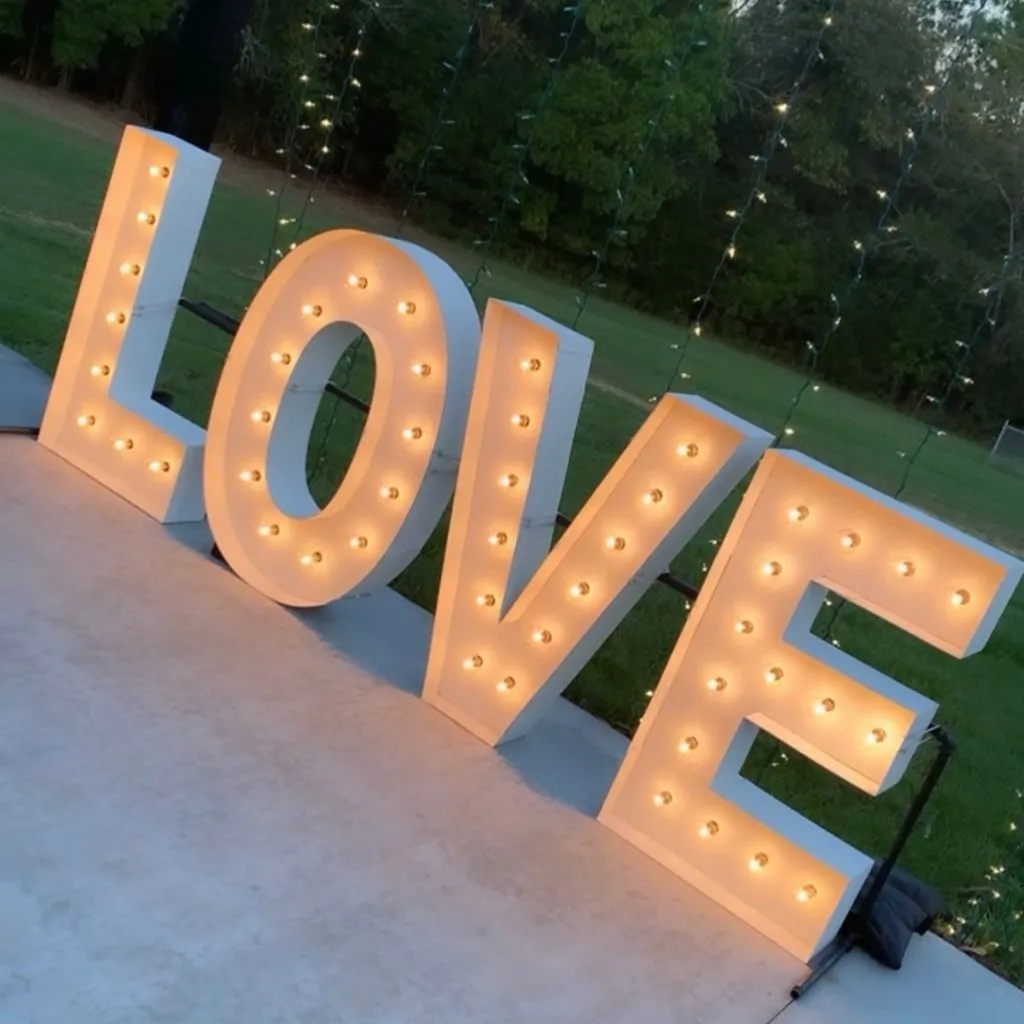 LOVE marquee sign glowing at an outdoor wedding reception at a venue in Gallatin TN.